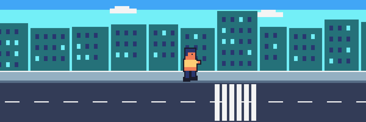 Una persona camina por una calle y un paso peatonal de la ciudad.